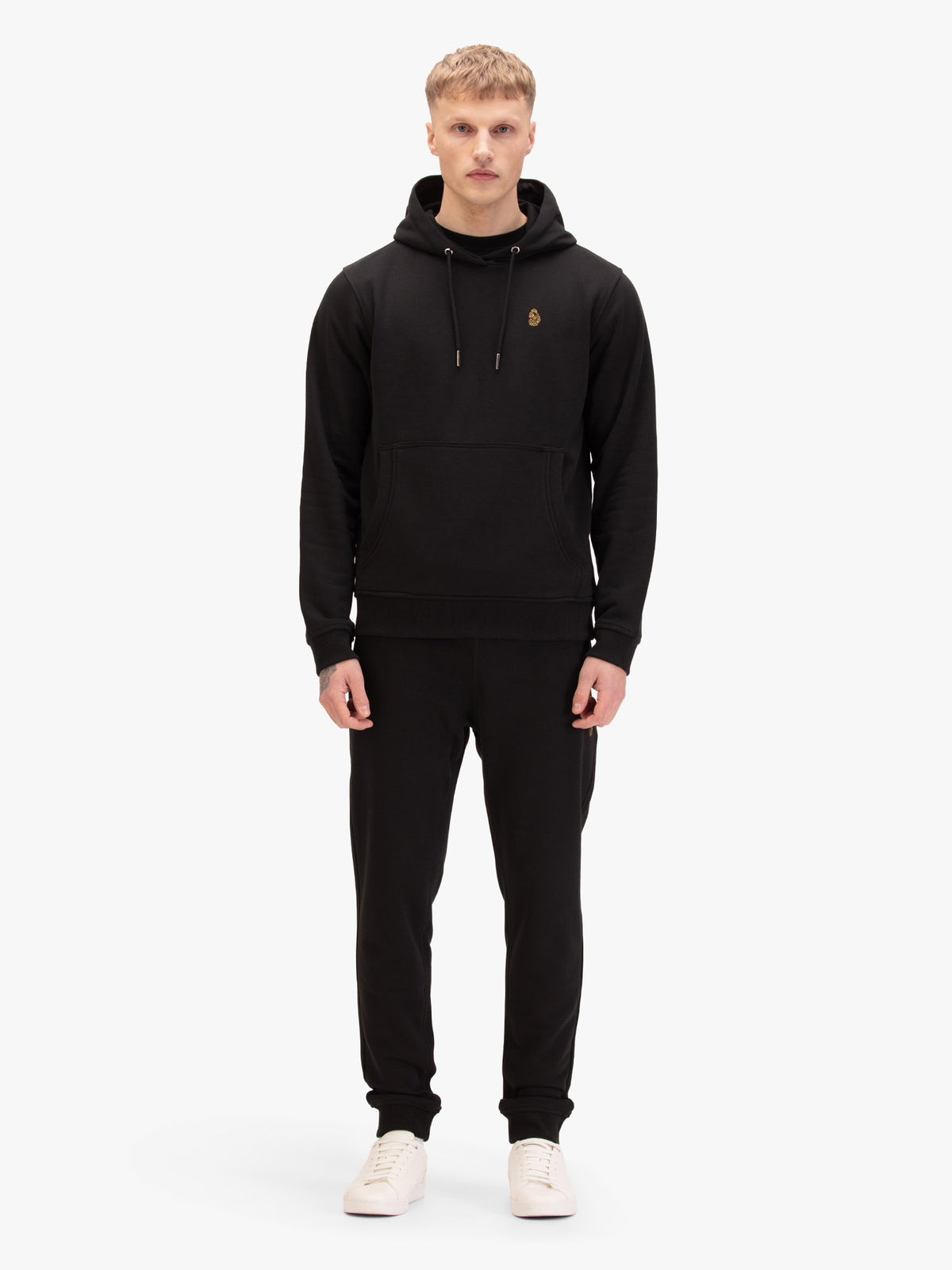 Men's black tracksuit with hoodie and matching joggers, worn by model.