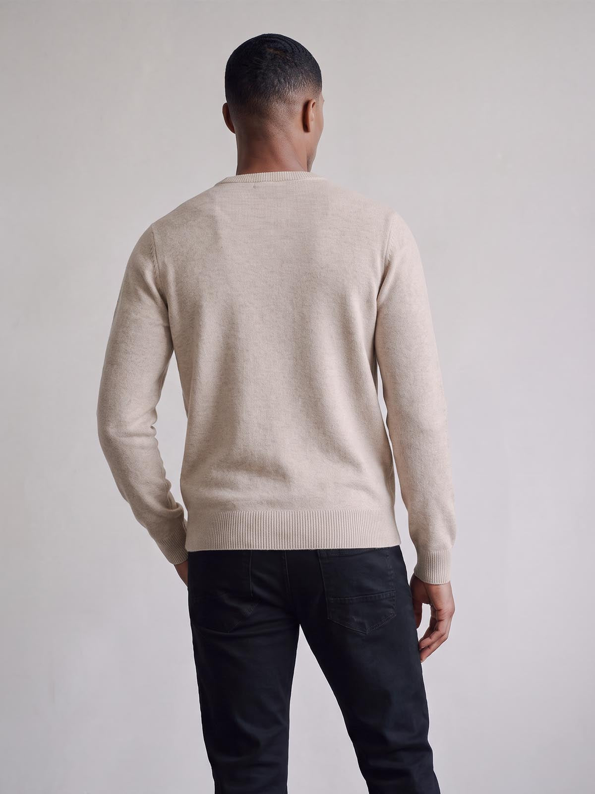 Back view of stone marle LUKE 1977 Gerard knitted jumper worn by model