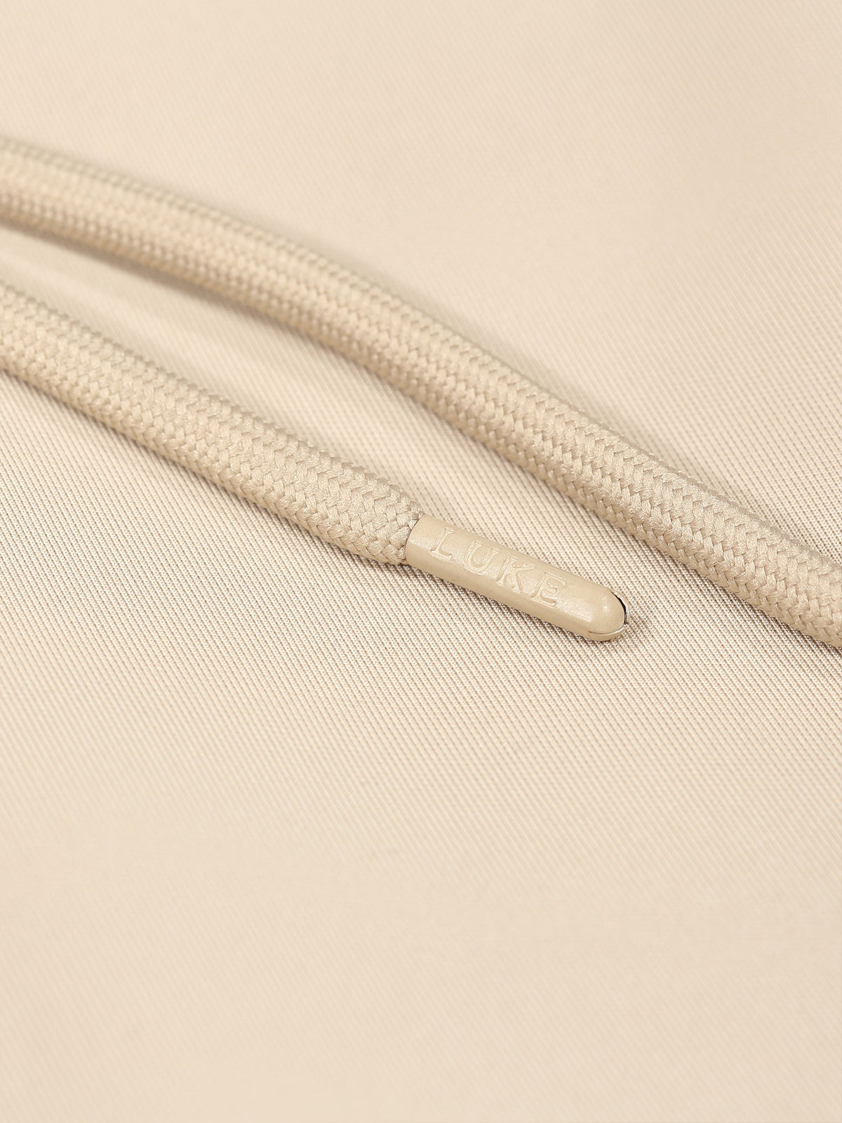 Close-up of drawcord with tonal metal ends on stone TTTST tricot shorts