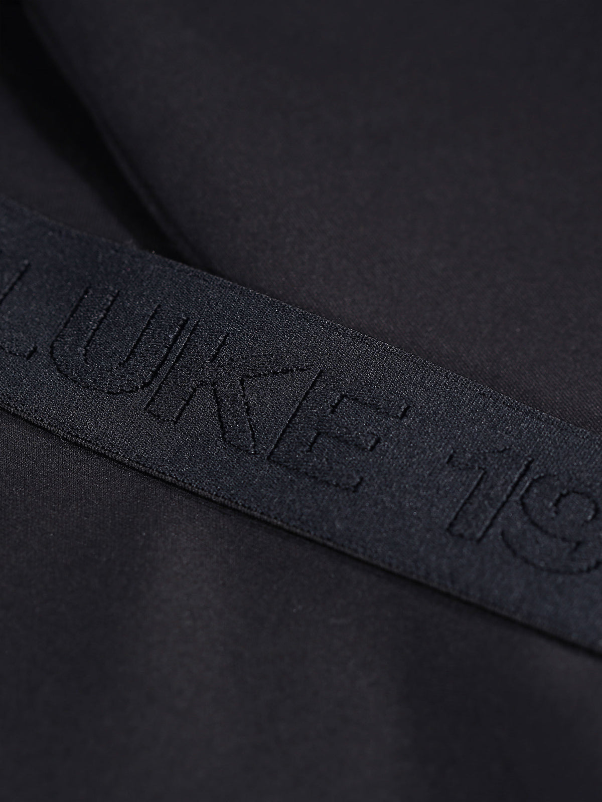 Boy's black sweatshirt with crew neck and tricot, tape detail view