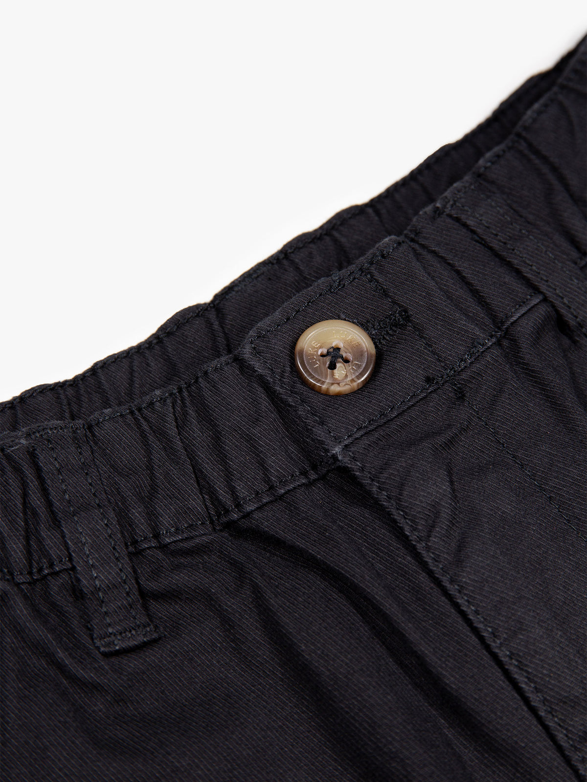 Boy's black trousers with cotton, button detail view