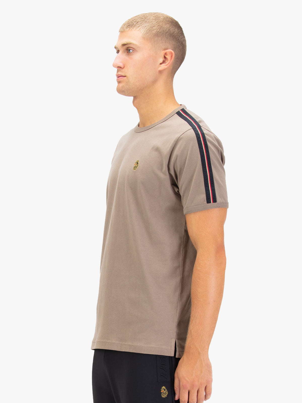 Men's brown t-shirt with crew neck and short sleeves, worn by a model, side view