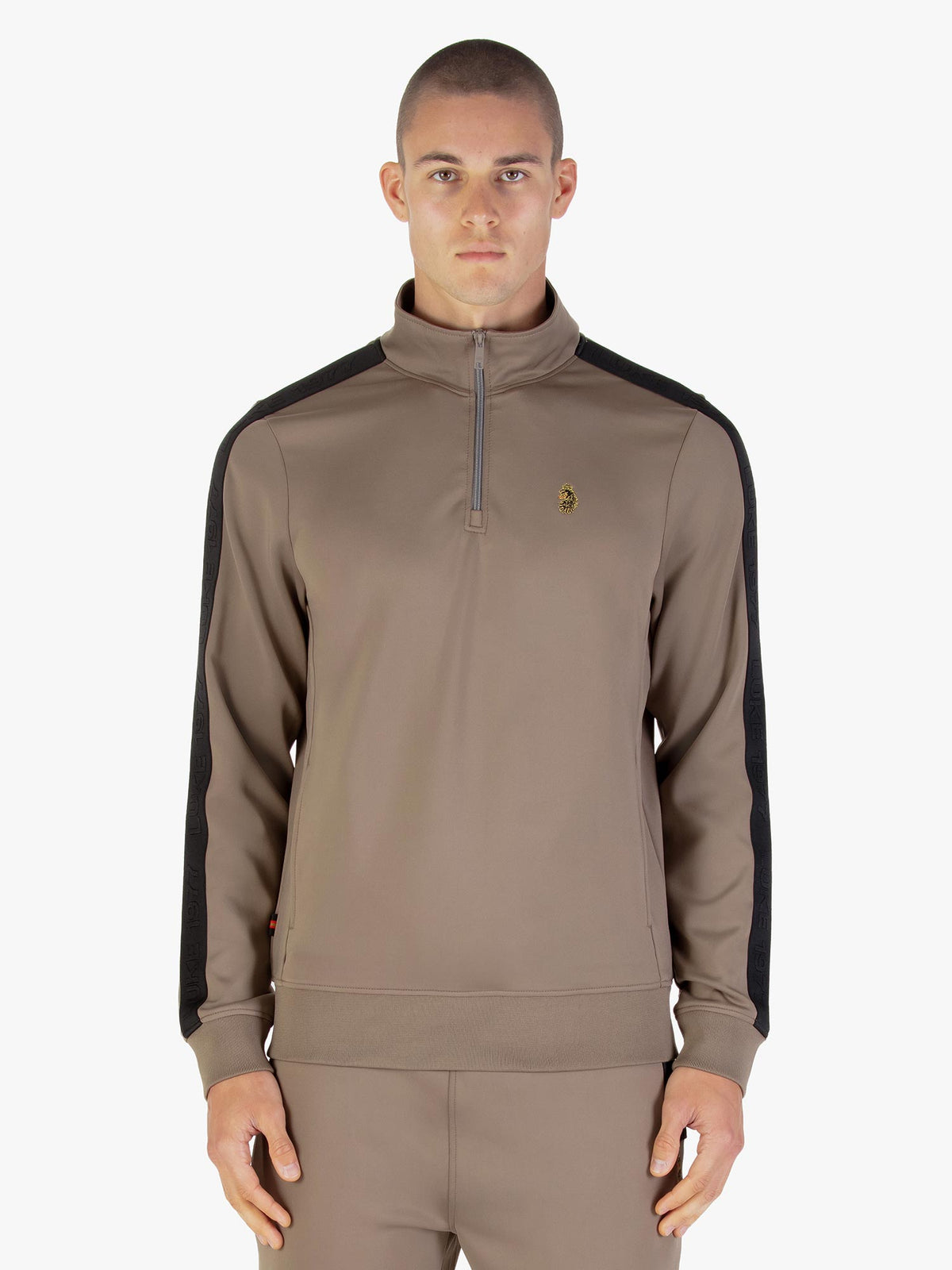 Man wearing brown LUKE 1977 TTTQR quarter zip tricot sweatshirt, front view
