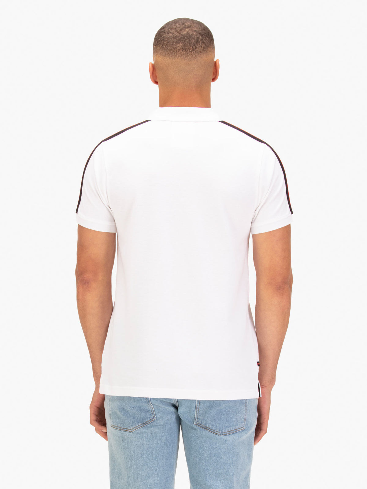 Back view of white LUKE 1977 New Willtape polo shirt worn by model