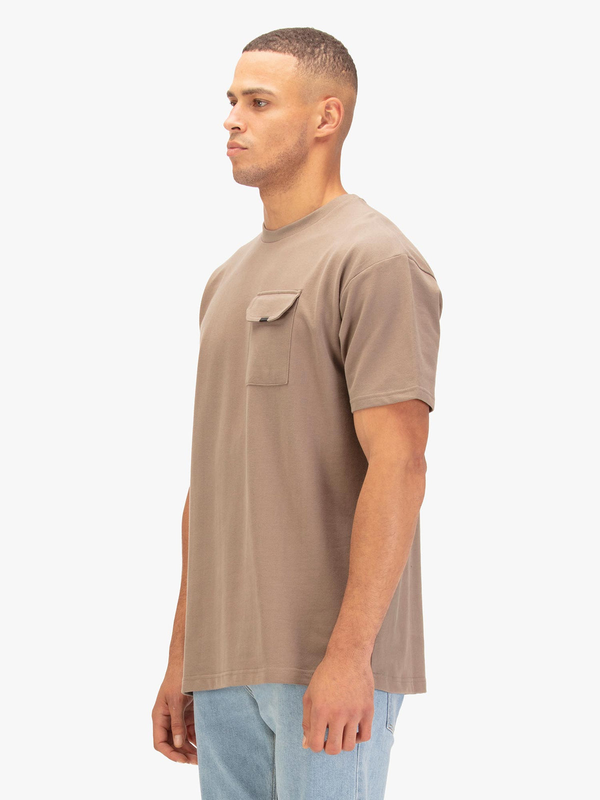 Men's relaxed-fit brown t-shirt with crew neck and short sleeves, worn by a model, side view