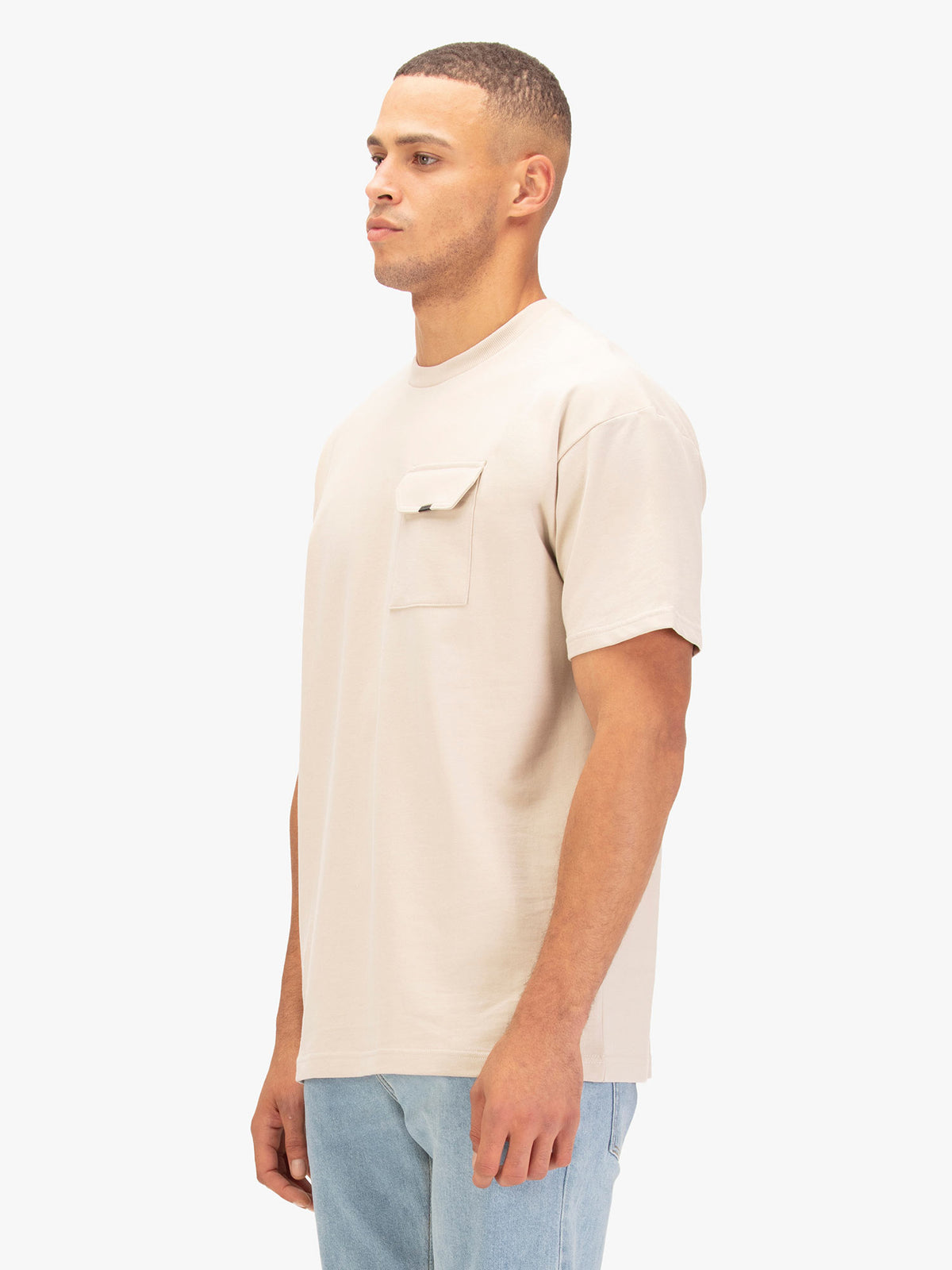 Men's relaxed-fit beige t-shirt with crew neck and short sleeves worn by a model - side view.