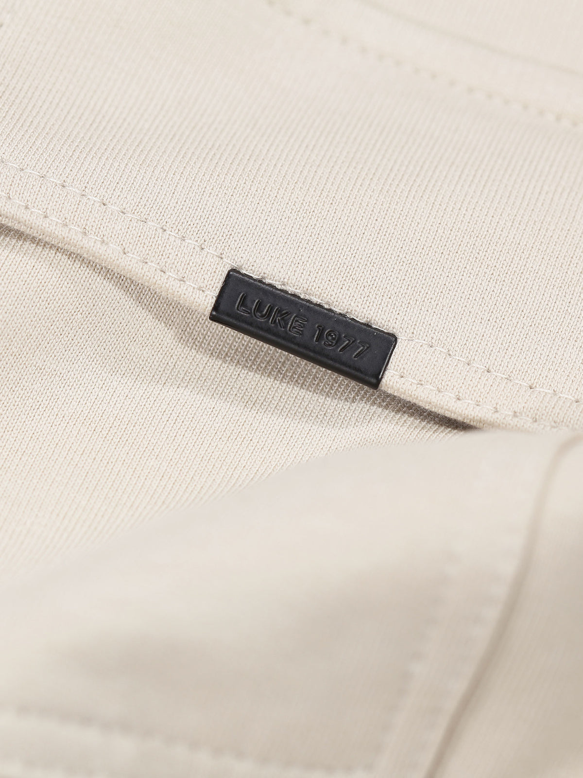 Men's relaxed-fit beige t-shirt with crew neck and short sleeves.