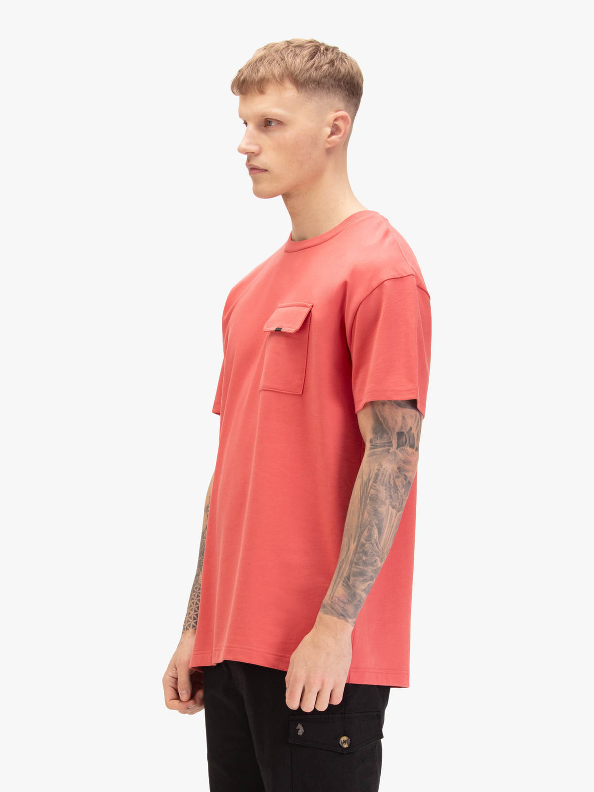 Men's relaxed-fit red t-shirt with crew neck and short sleeves, worn by a model, side view