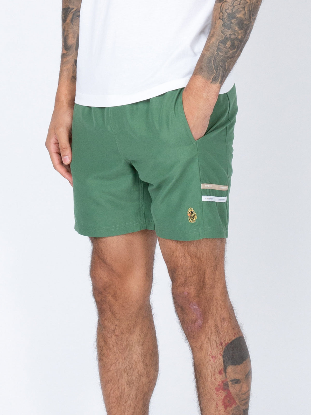 Men's green swim shorts with drawstring waistband.