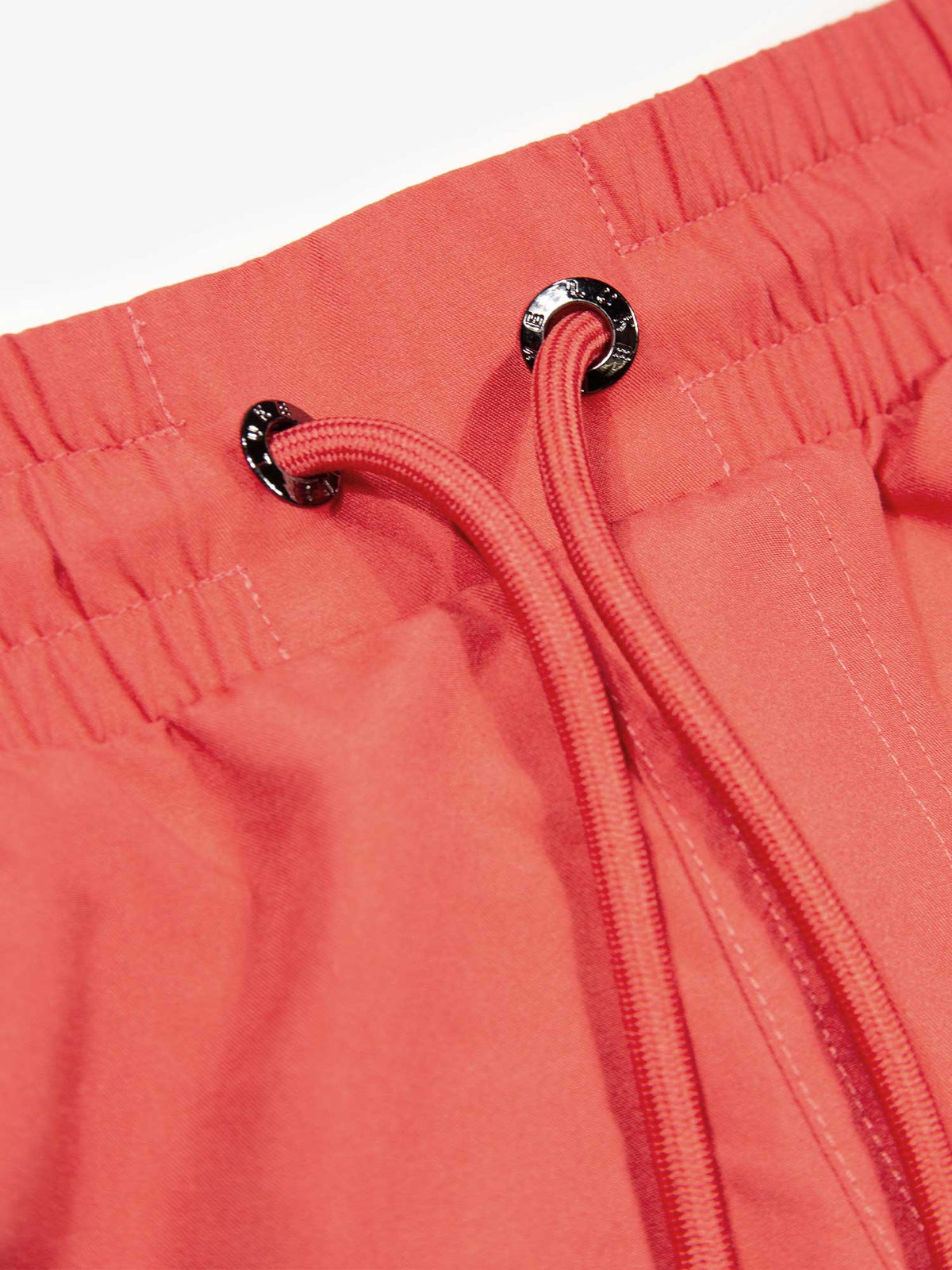 Men's red swim shorts with drawstring waistband, detail view 1