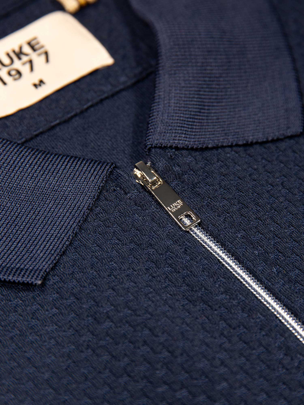 Men's navy polo shirt with polo collar, detail view