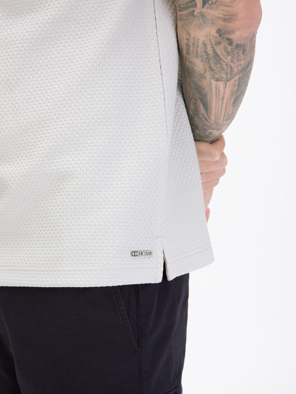 Men's grey polo shirt with polo collar, worn by a model