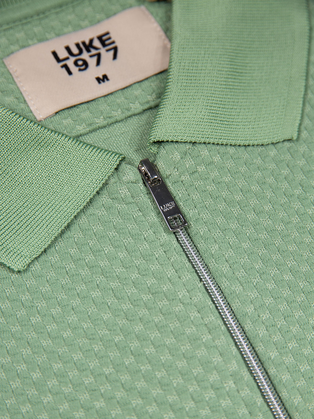 Men's green polo shirt with polo collar, detail view