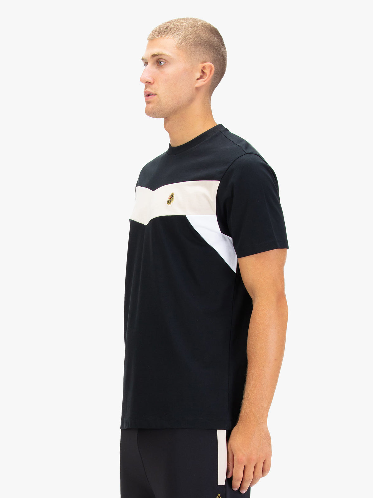 Men's black t-shirt with crew neck and short sleeves, worn by a model, side view