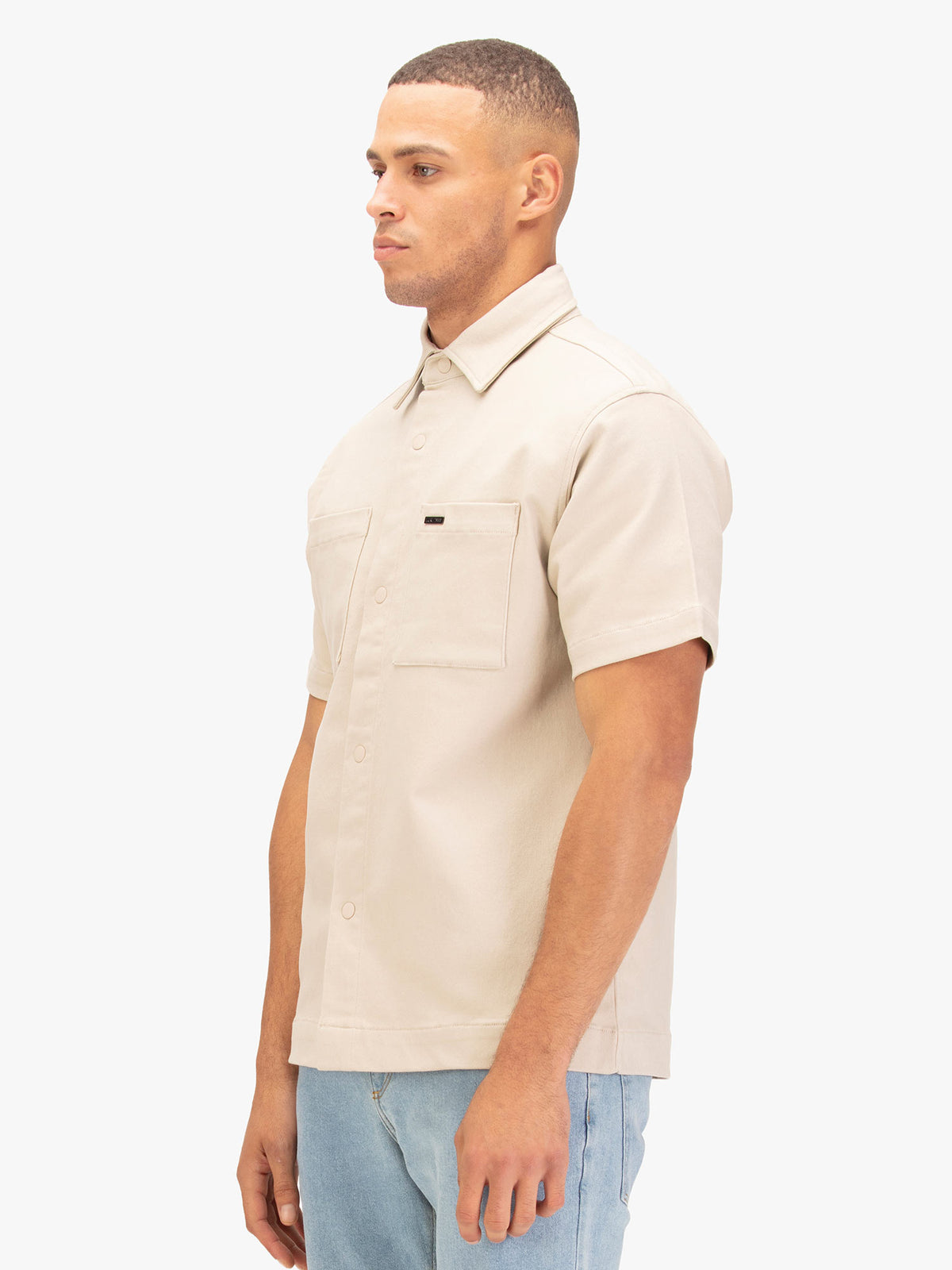 Men's beige shirt with button-up front.