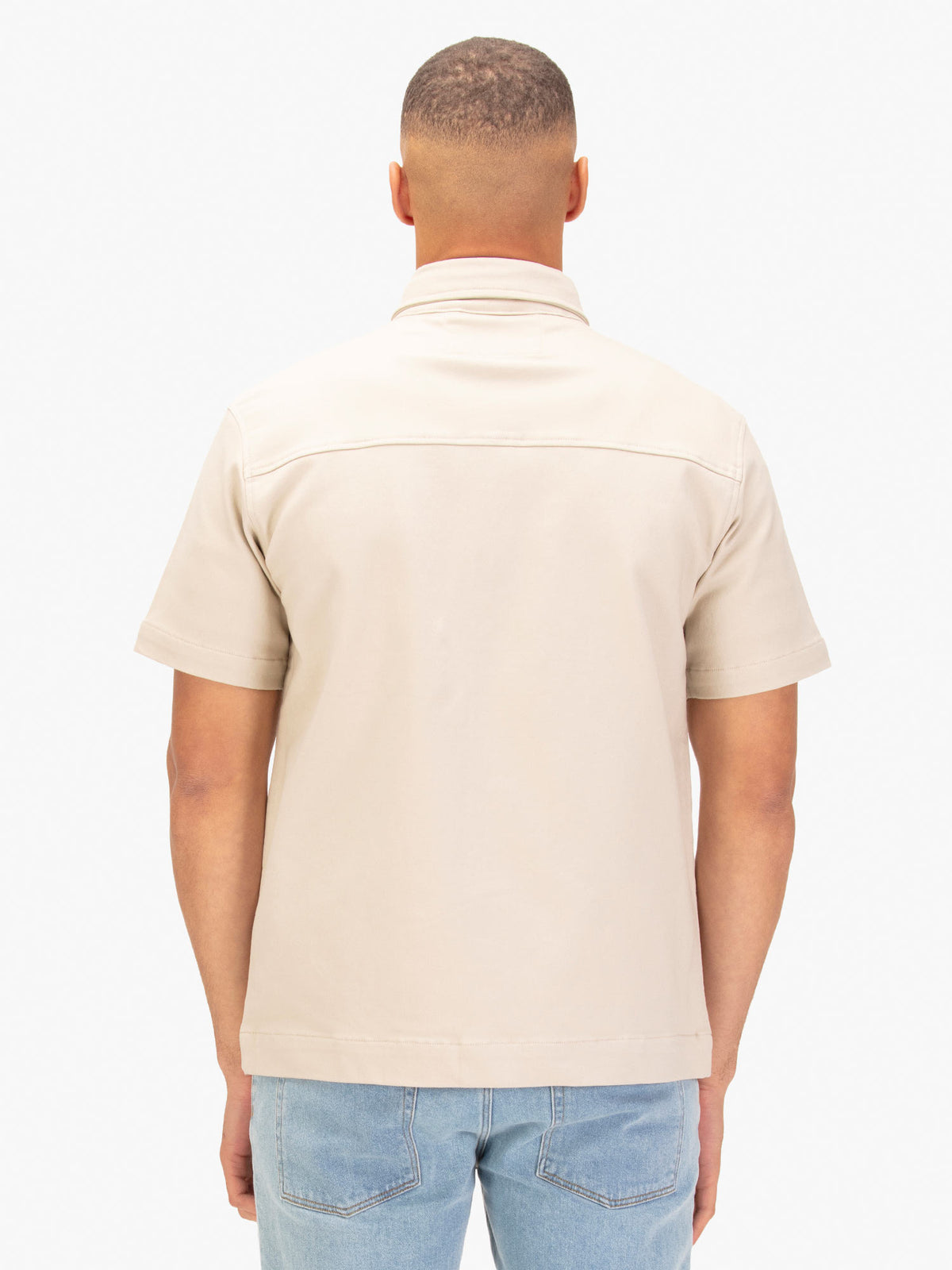 Men's beige shirt with button-up front.