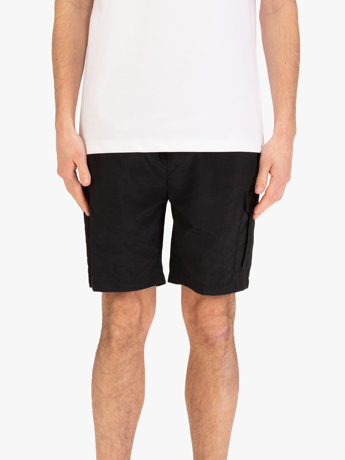 Men's black shorts with elasticated waistband, worn by a model, front view