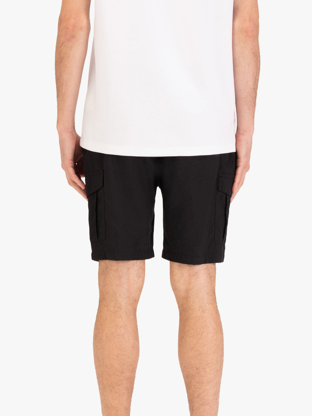 Men's black shorts with elasticated waistband, worn by a model, back view