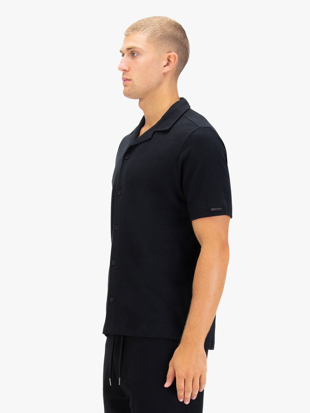 Men's black shirt with button-up front.