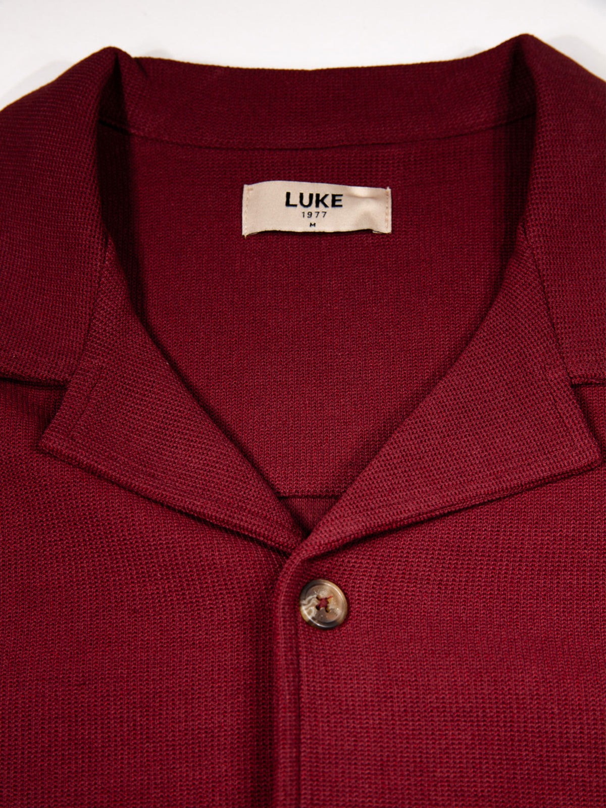Men's red shirt with button-up front.