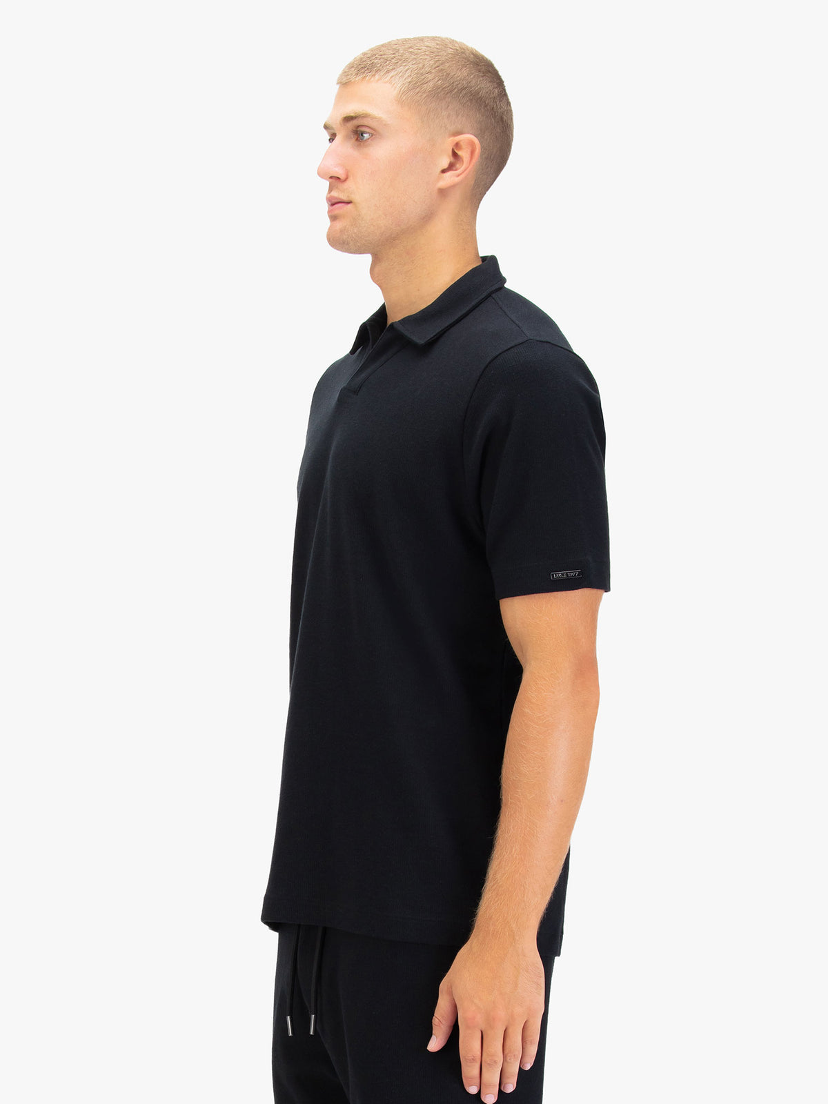 Men's black polo shirt with polo collar.