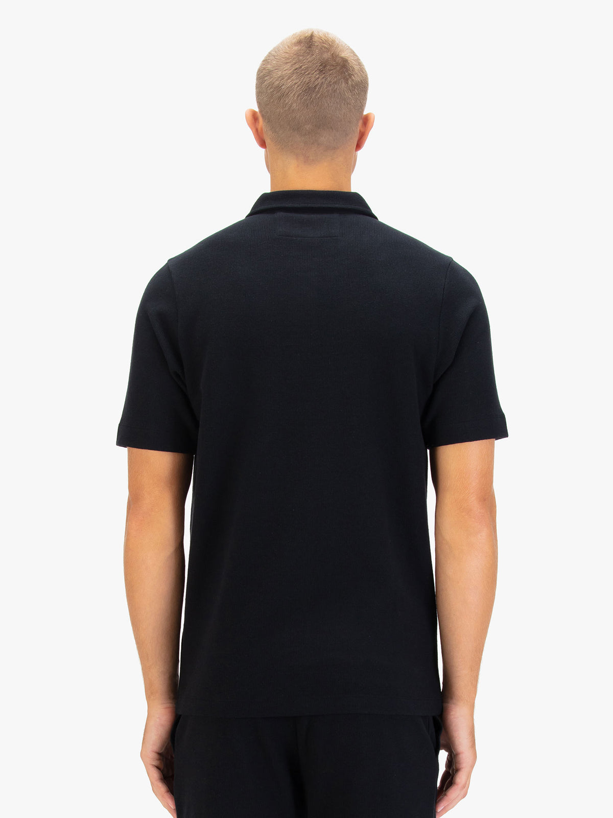 Men's black polo shirt with polo collar.