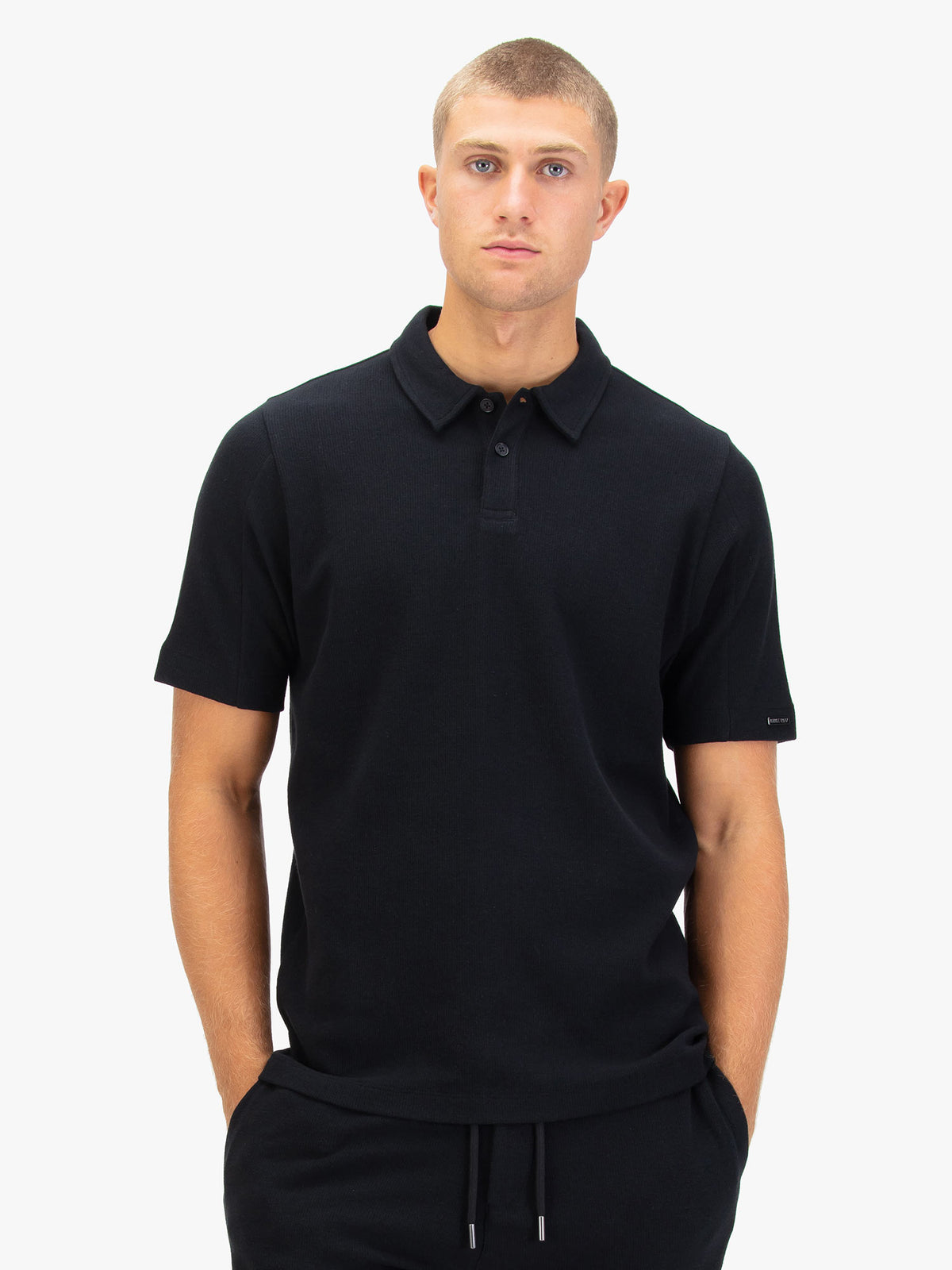 Men's black polo shirt with polo collar.
