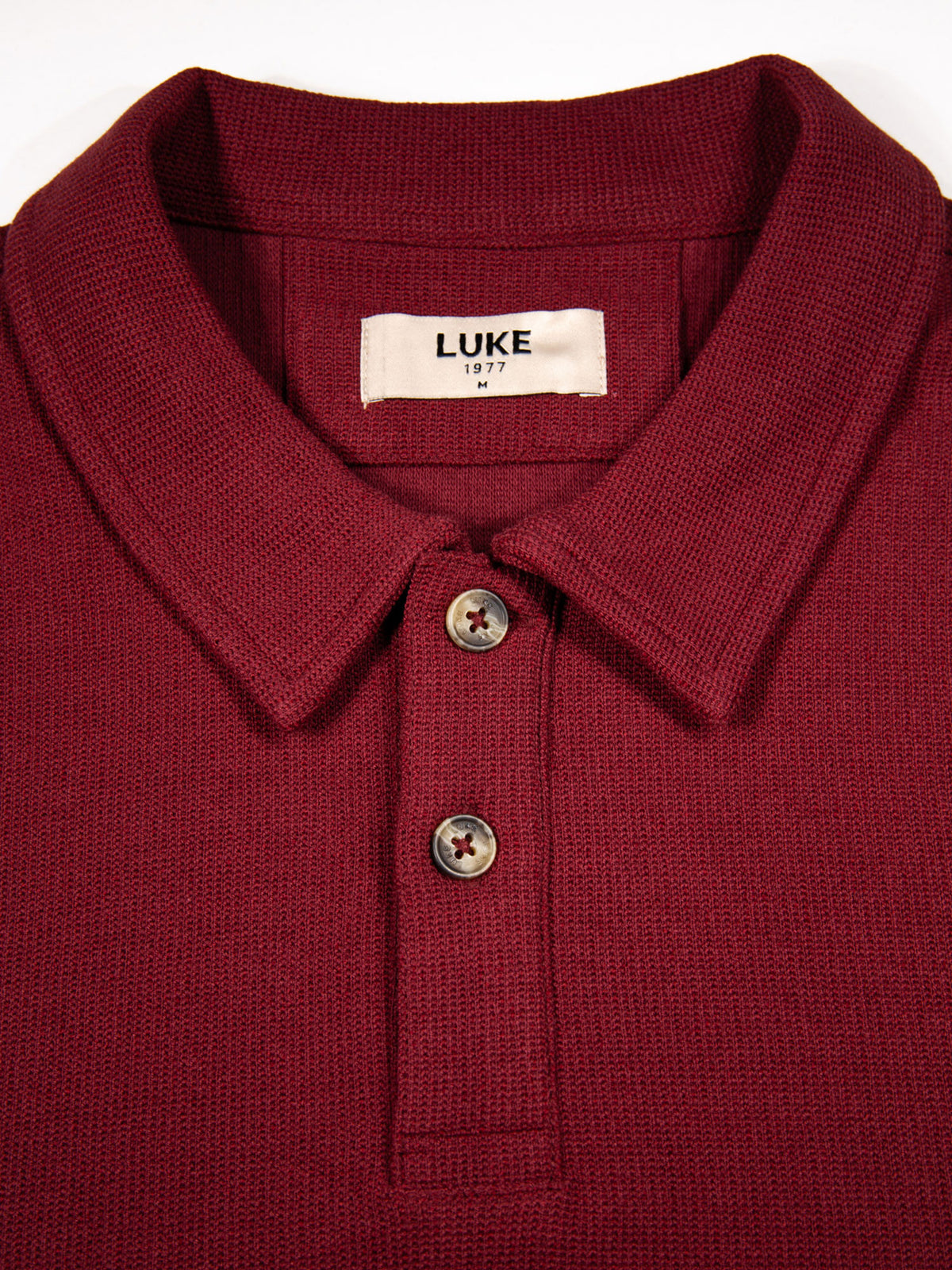 Men's red polo shirt with polo collar.