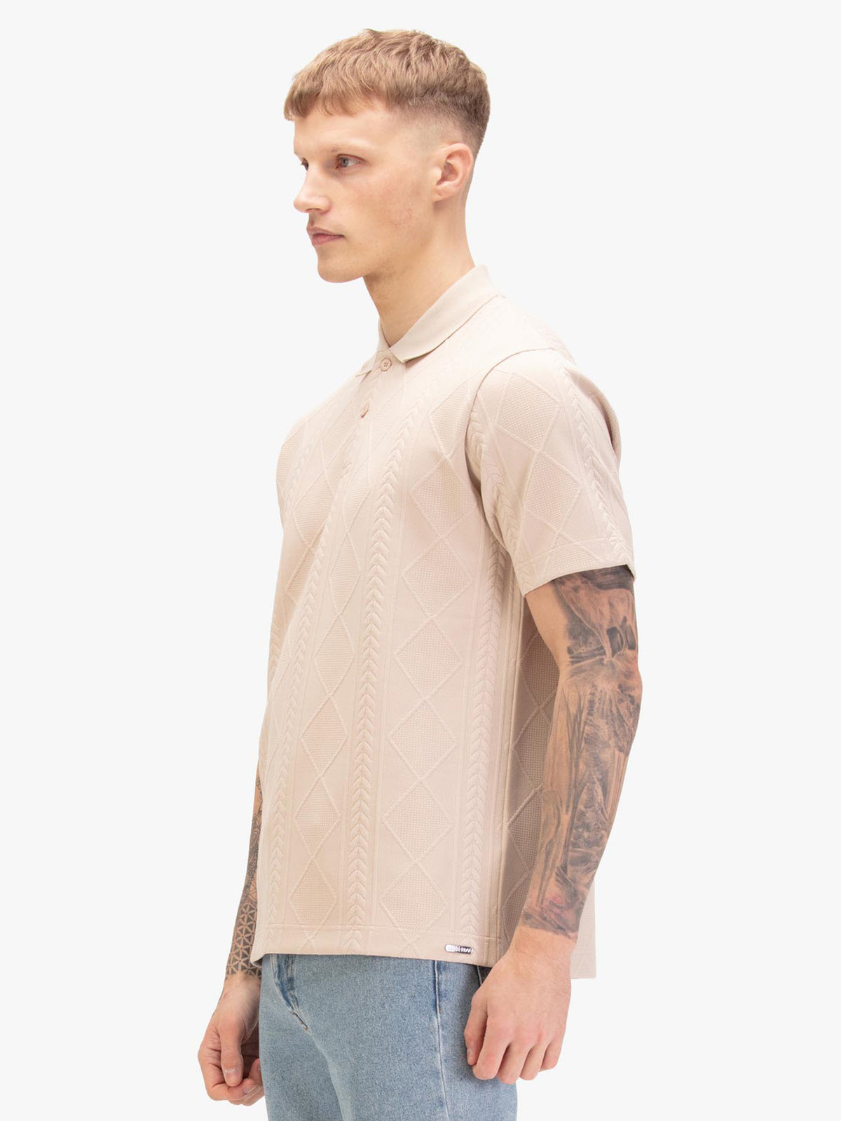 Men's beige polo shirt with polo collar, worn by a model, side view