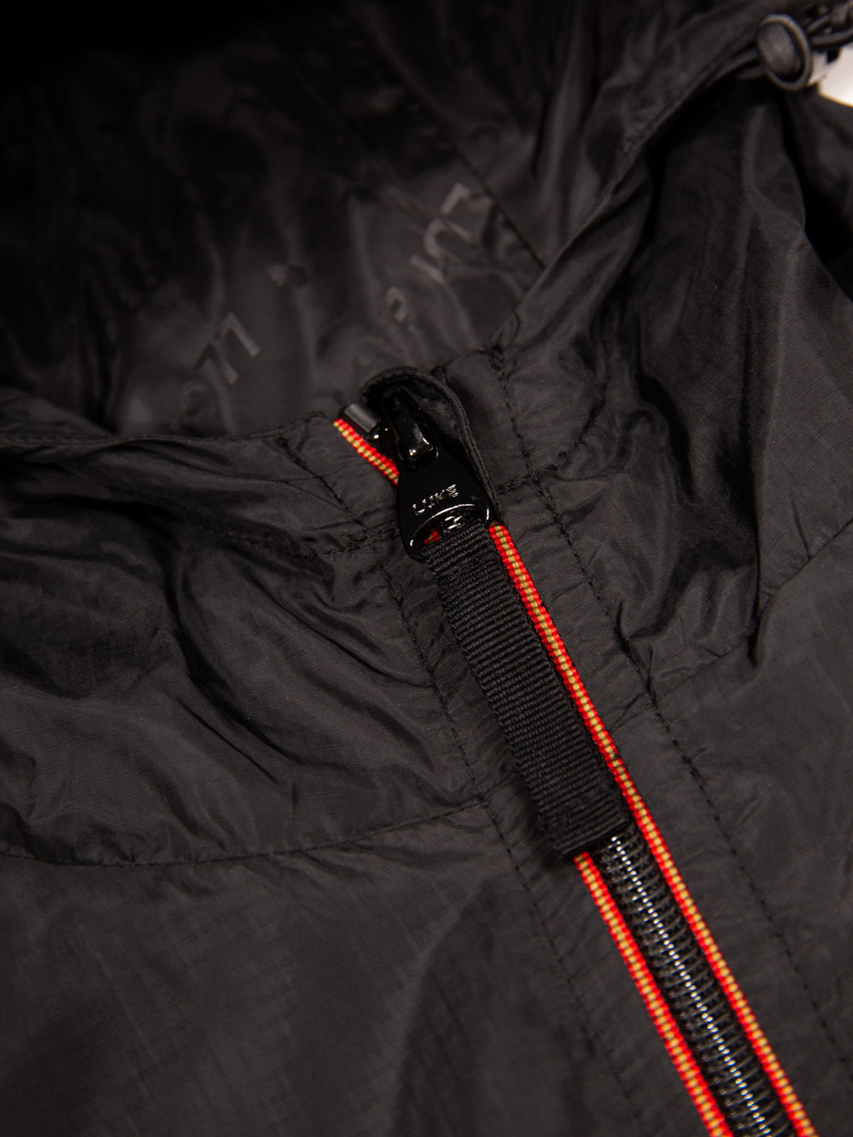 Men's black jacket with zip-up front.