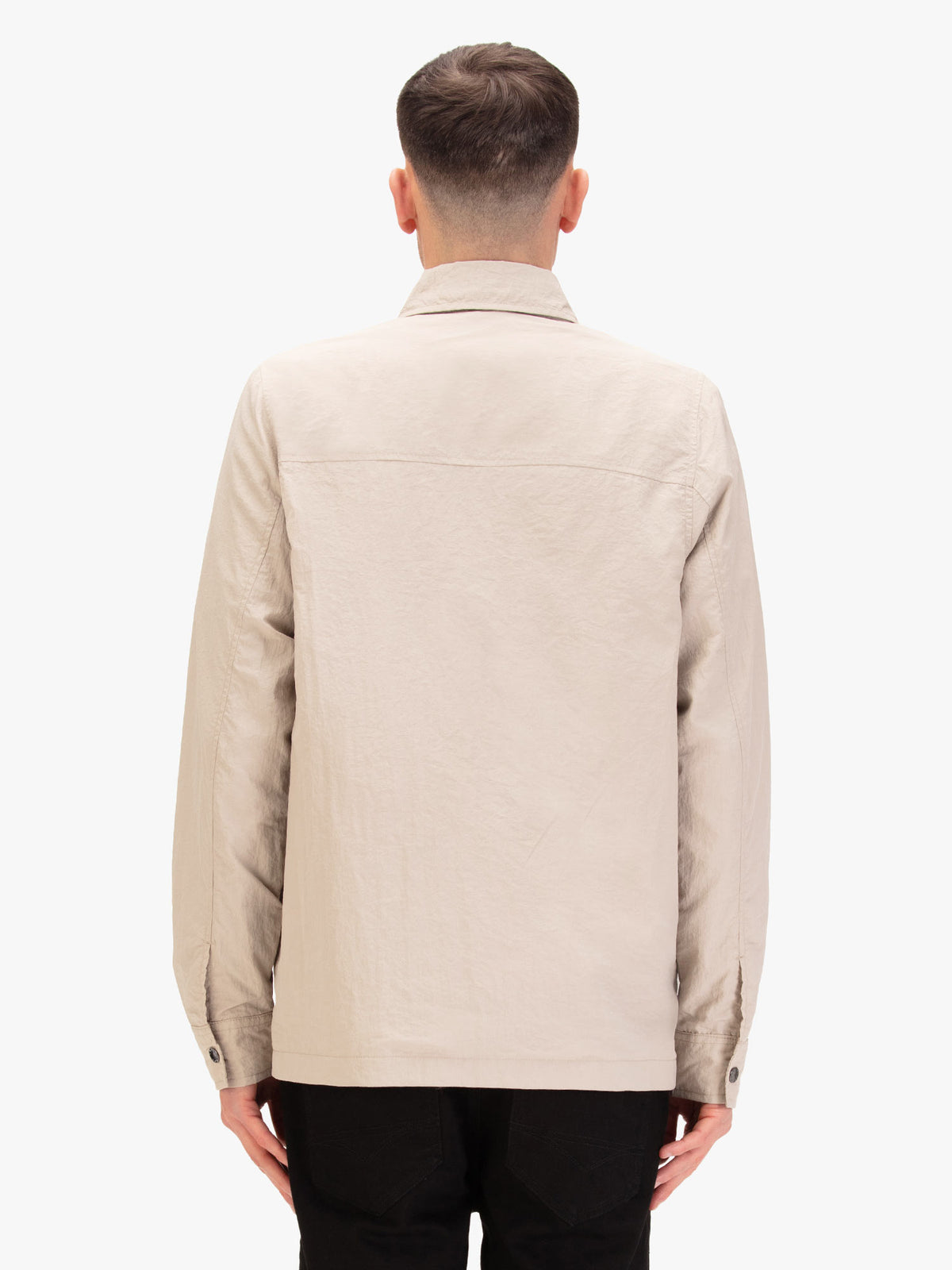 Men's beige jacket with button-up front and chest pocket, worn by a model, back view