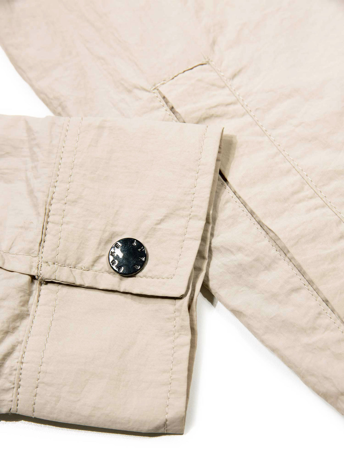 Men's beige jacket with button-up front and chest pocket.