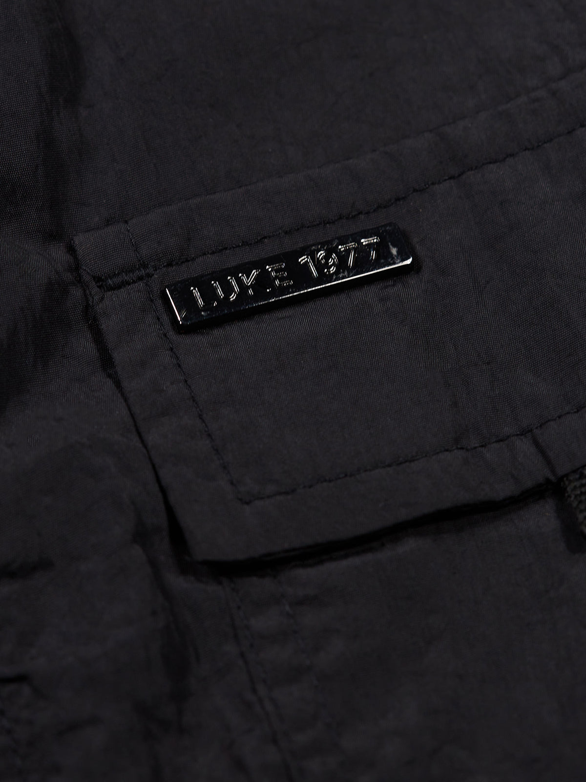 Men's black jacket with front pocket.
