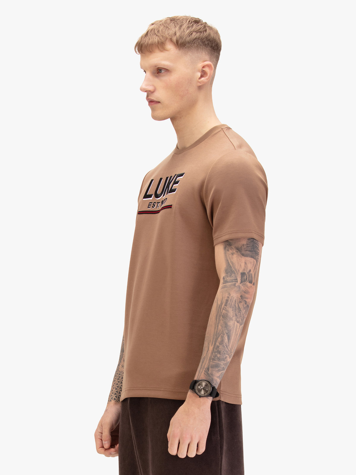 Men's brown t-shirt with crew neck and short sleeves worn by a model - side view.