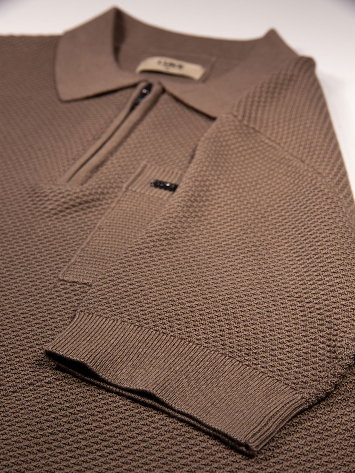 Men's brown knitted polo with polo collar.