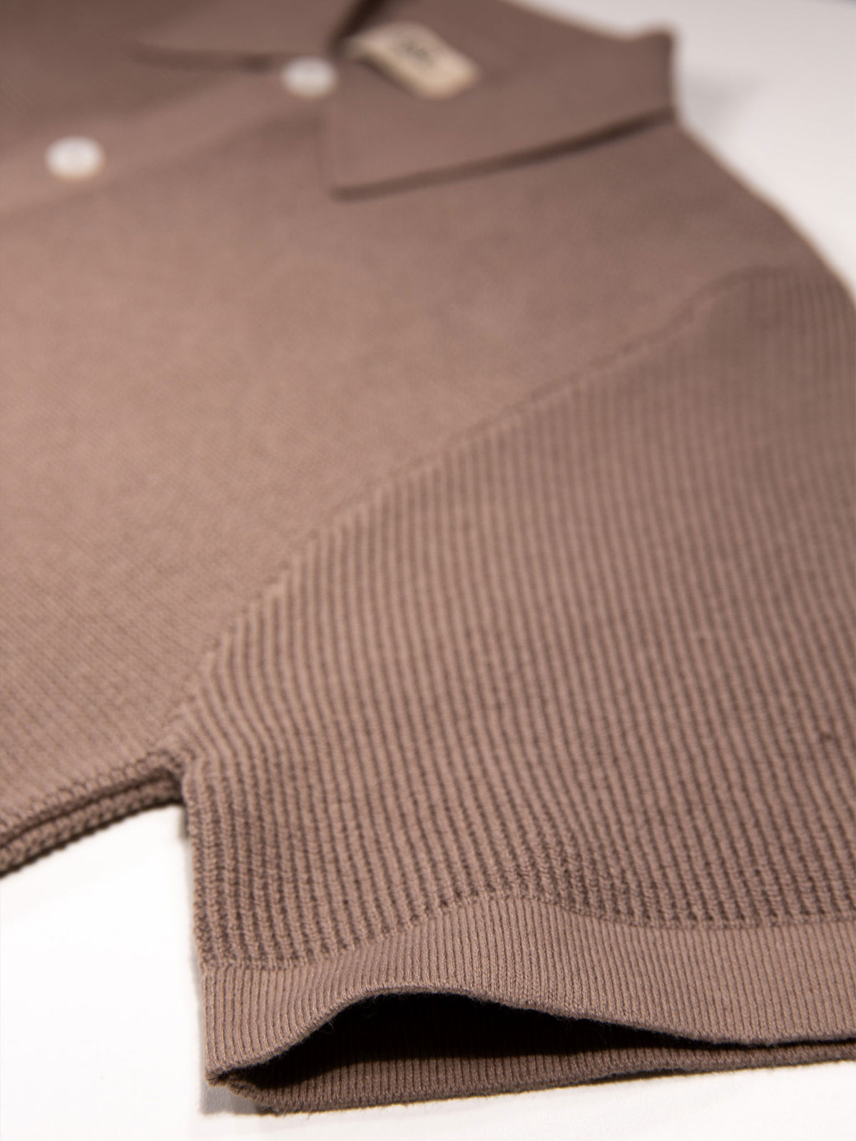 Men's brown knitted polo with polo collar.
