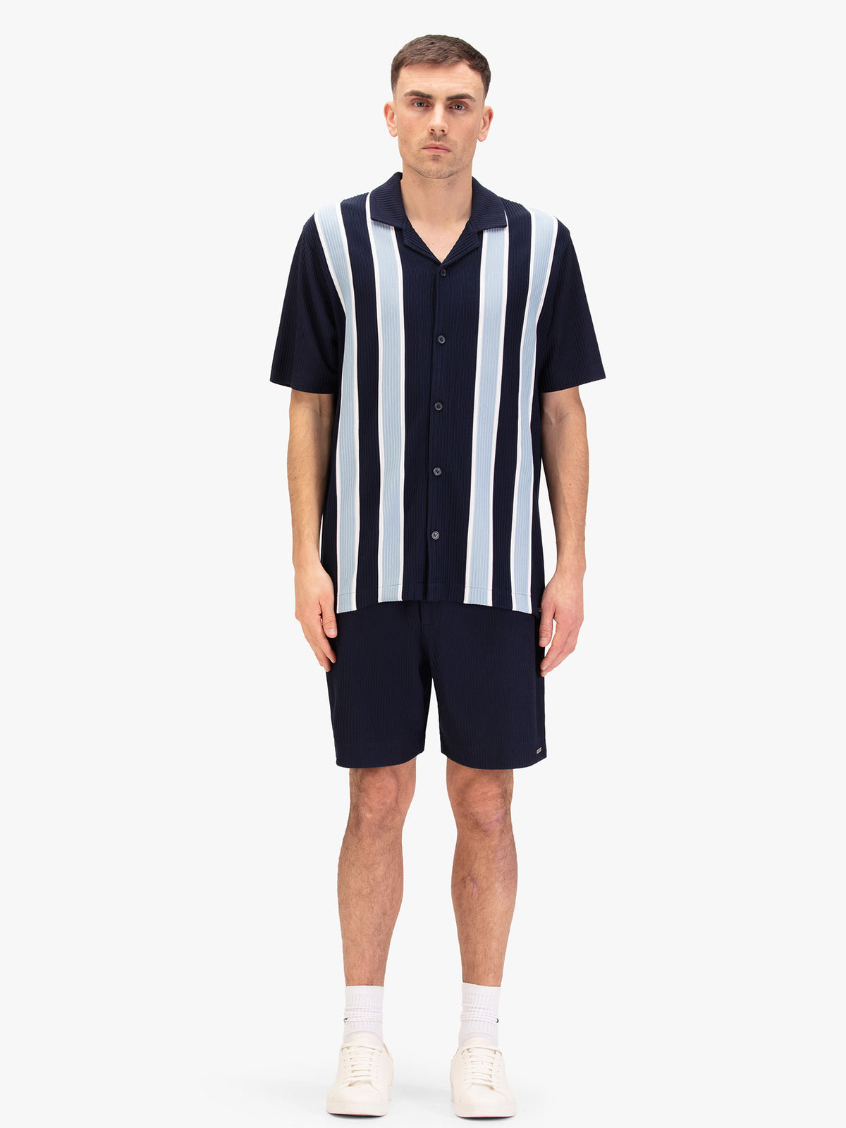 Men's navy short set with short-sleeve Cuban collar shirt and matching shorts, worn by a model.