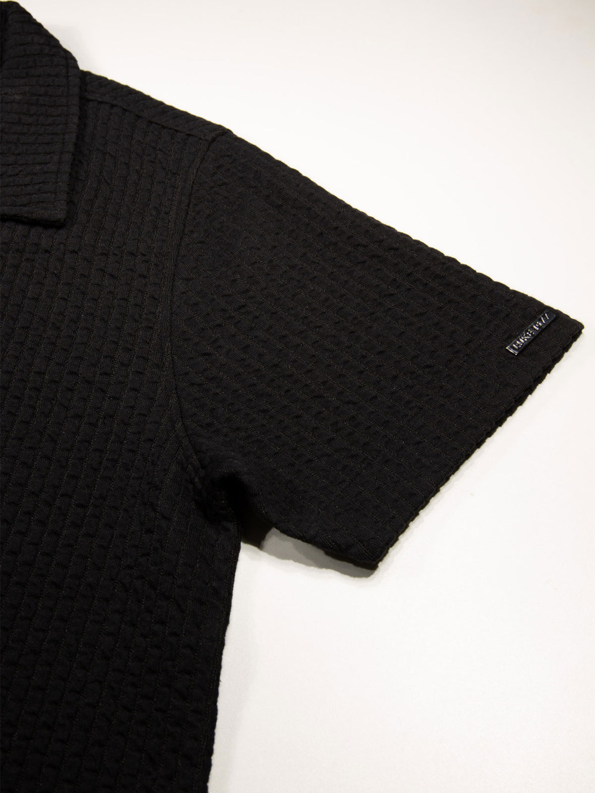 Men's black shirt with button-up front.