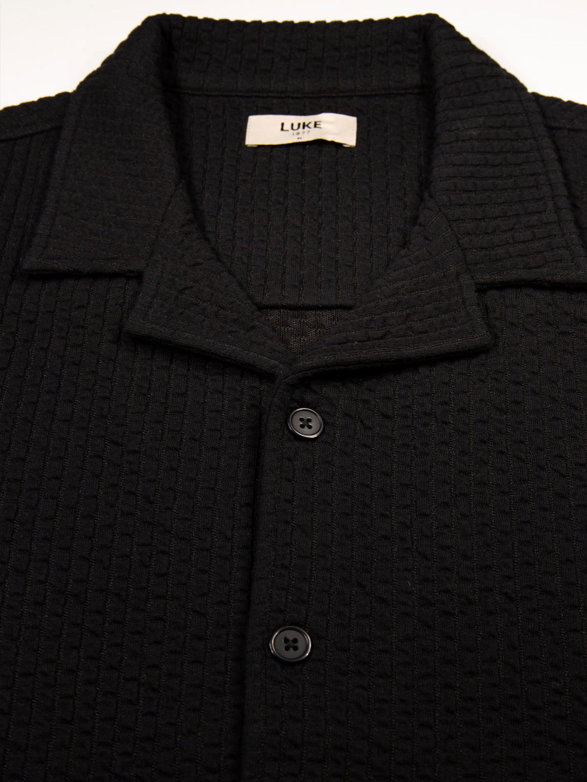 Men's black shirt with button-up front.