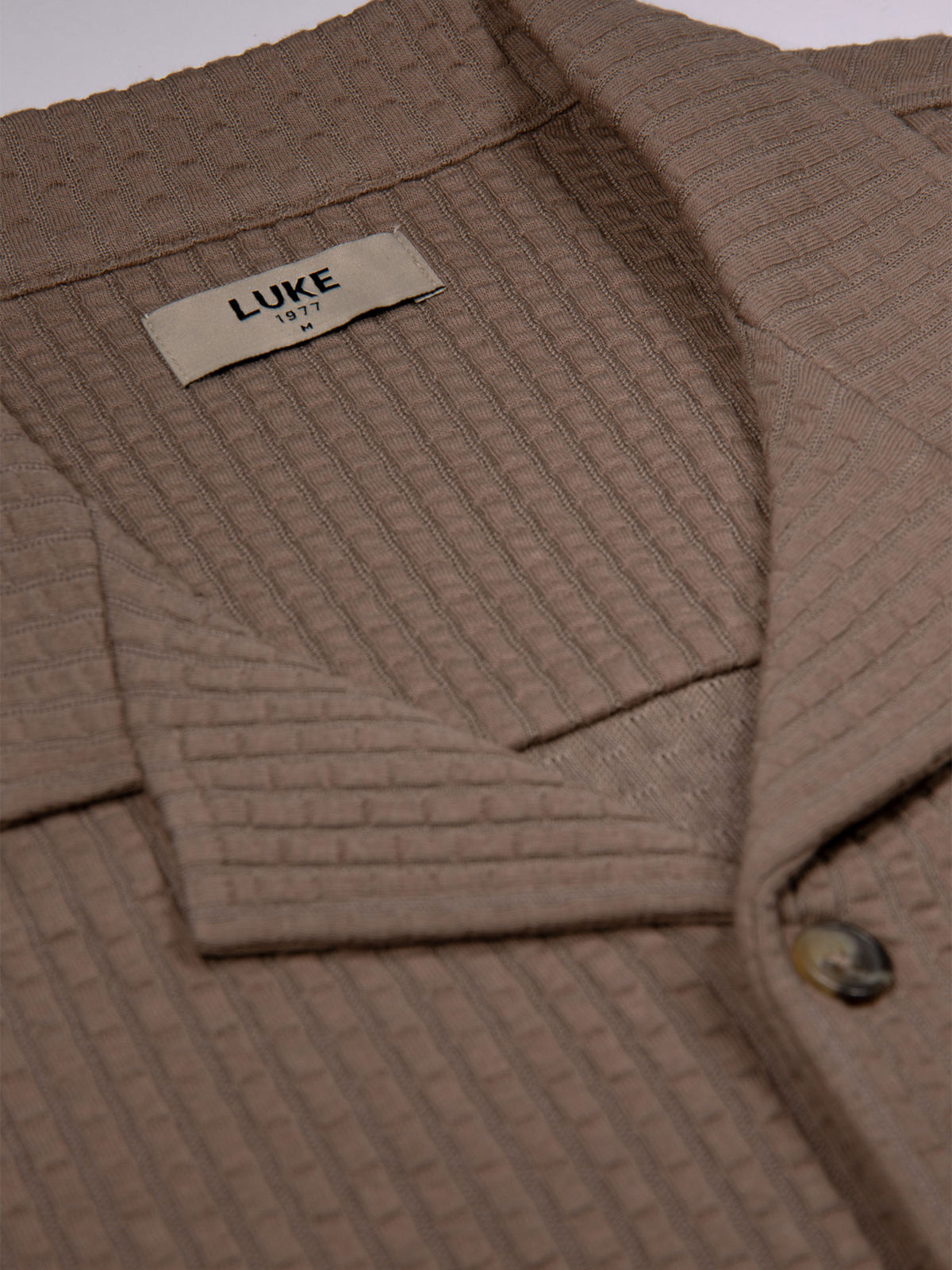 Men's brown shirt with button-up front.