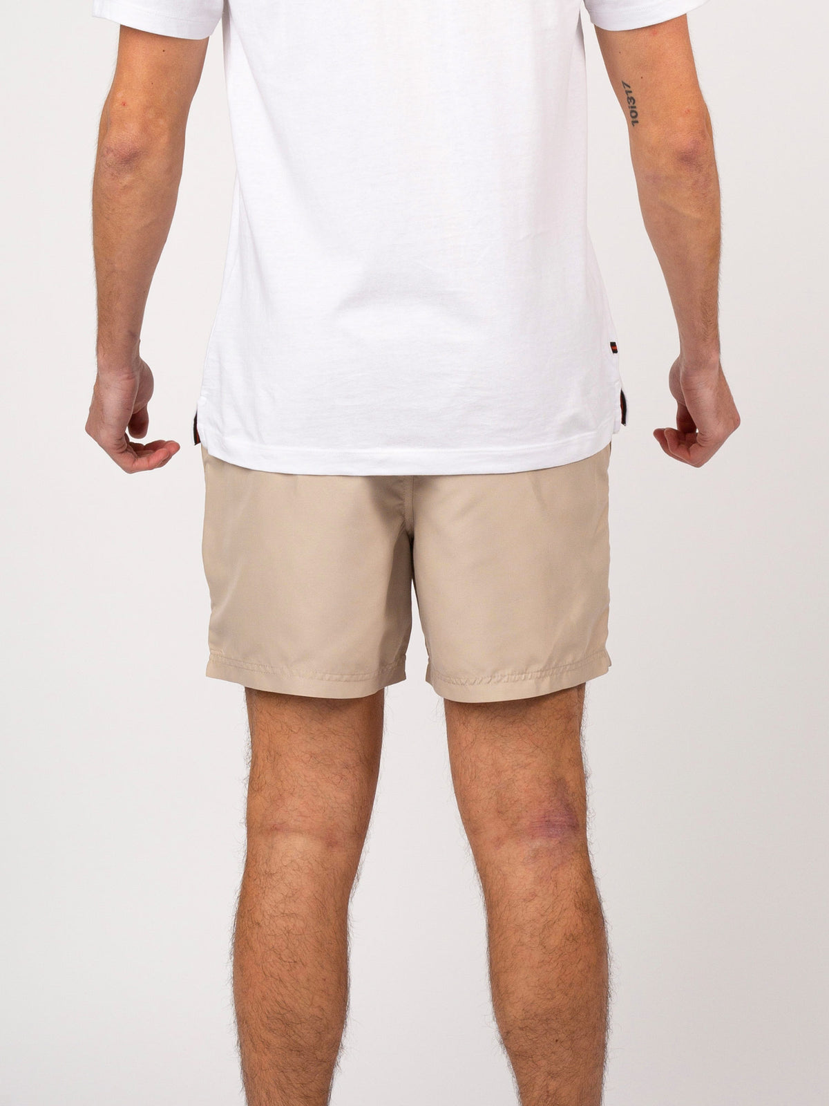 Men's beige swim shorts with drawstring waistband.