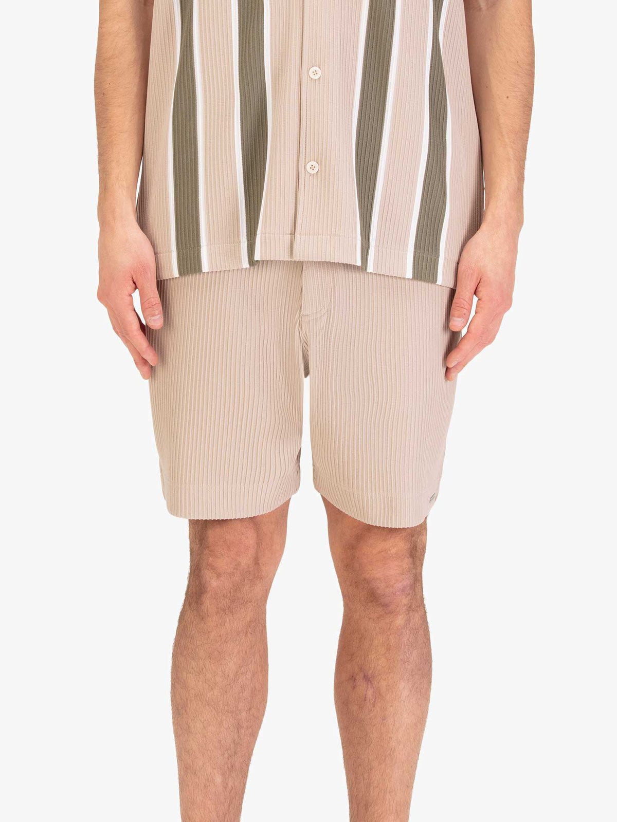 Men's beige shorts with drawstring waistband, worn by a model, front view