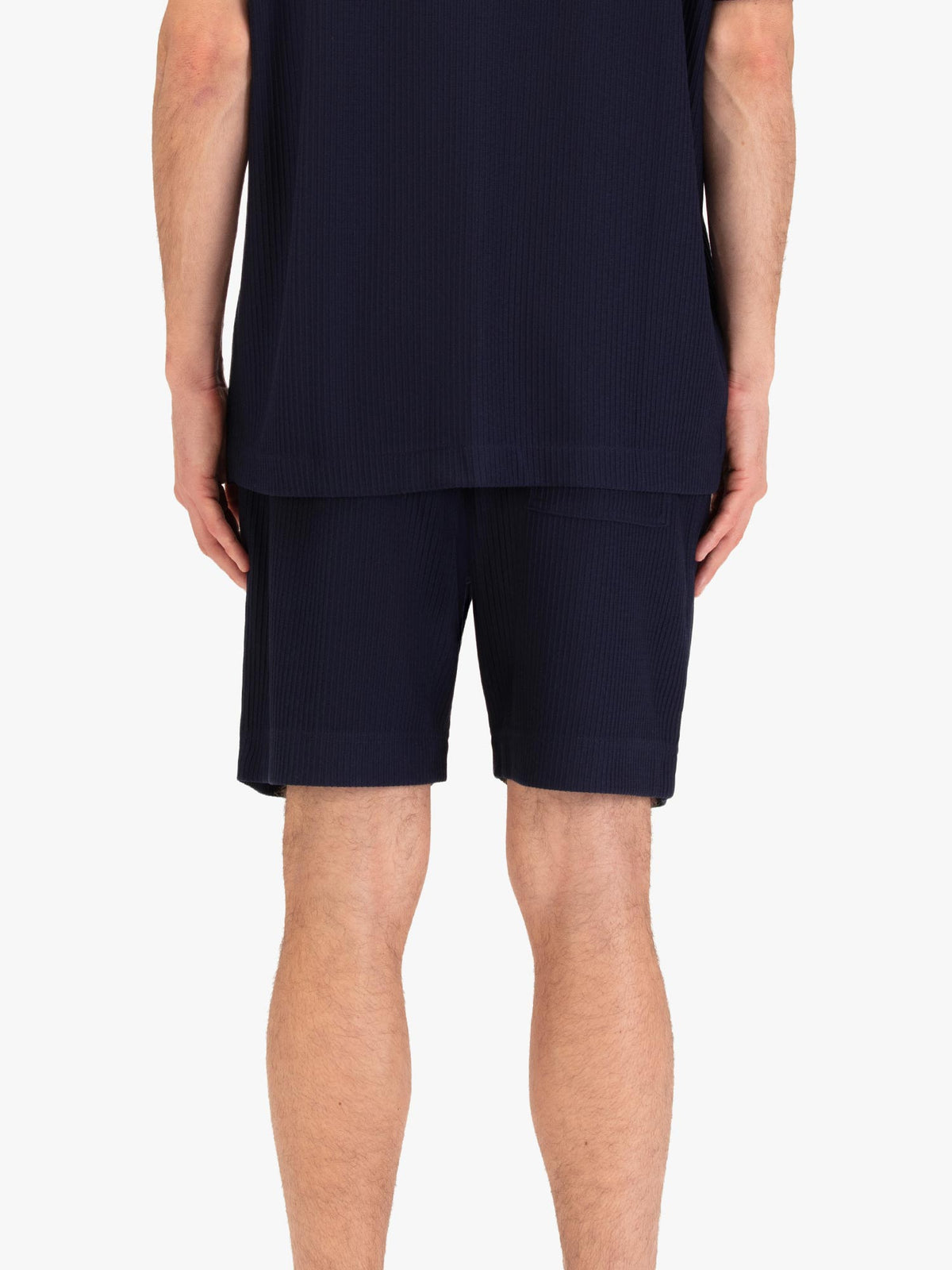Men's navy shorts with drawstring waistband, worn by a model, back view