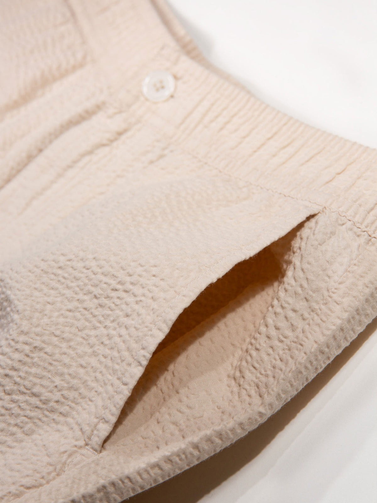 Men's beige shorts with drawstring waistband.