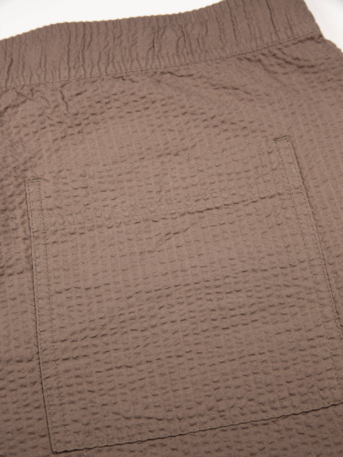 Men's brown shorts with drawstring waistband.