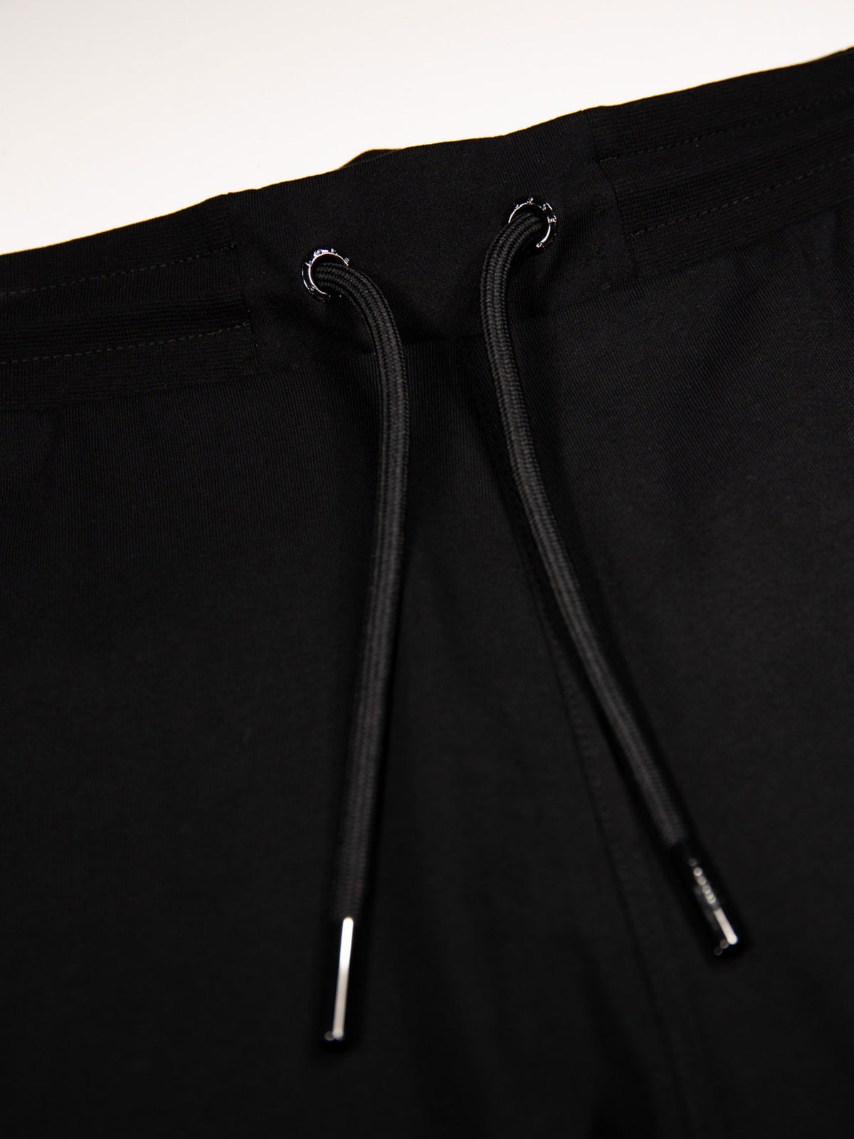 Men's black shorts with drawstring waistband, detail view 1