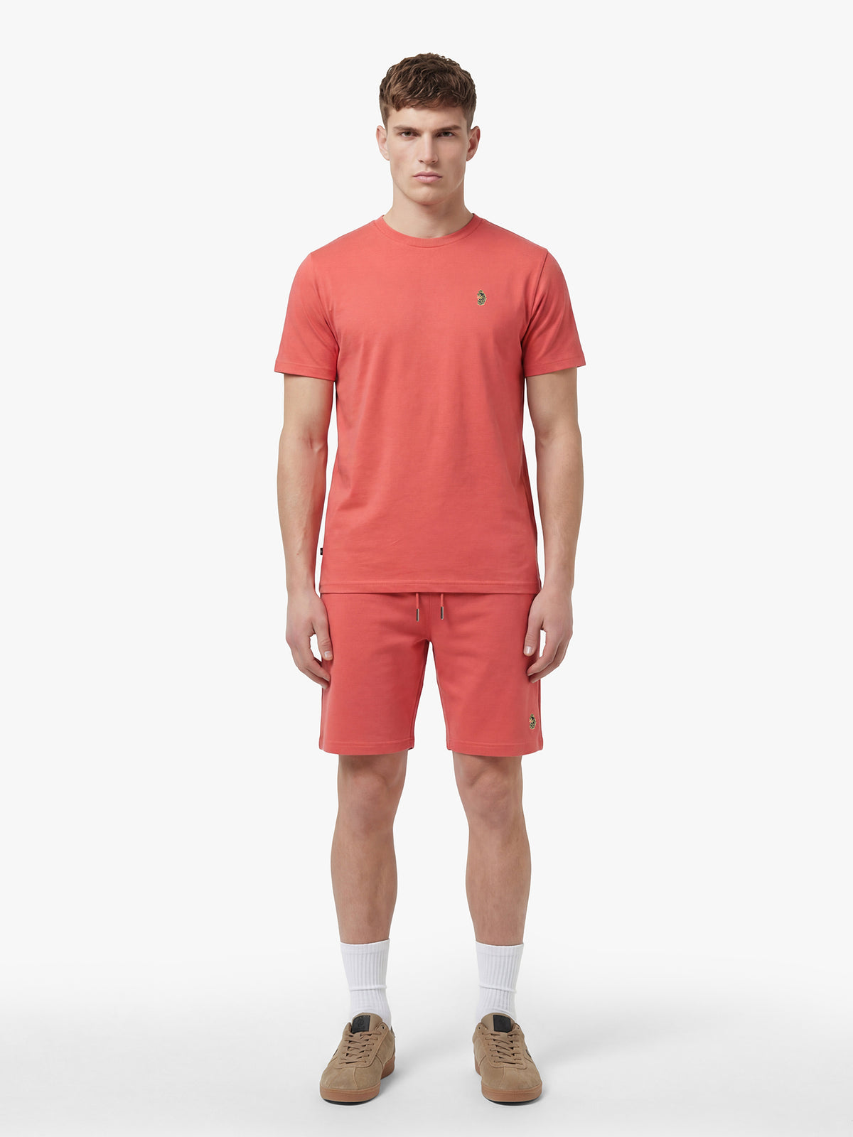 Men's red short set with short-sleeve shirt and drawstring shorts, worn by model.
