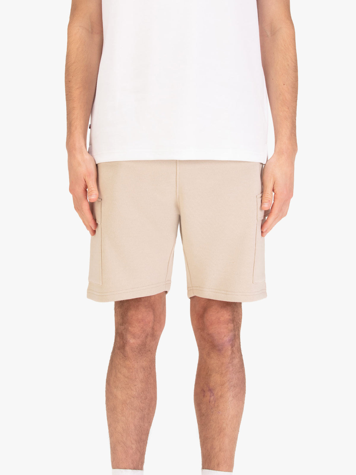 Men's beige shorts with elasticated waistband and cargo pockets, worn by a model, front view