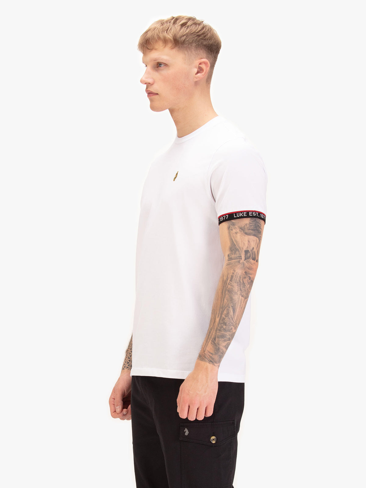 Side view of man wearing white LUKE 1977 San Diego t-shirt with rib sleeve cuffs