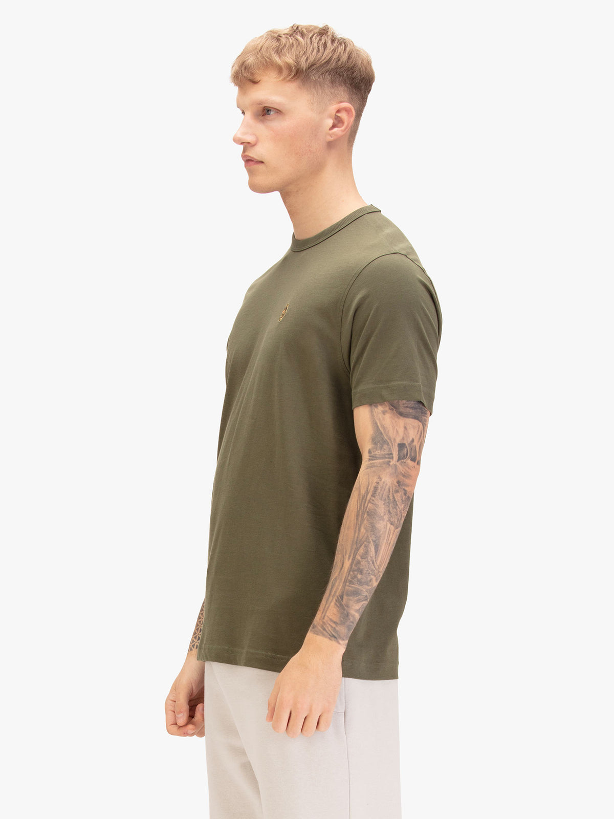 Men's green t-shirt with crew neck and short sleeves, worn by a model, side view